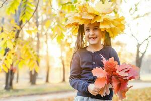 Autumn season leisure. Atmosphere of autumn. Adorable smiling schoolgirl autumn foliage background. Good mood. Happy child. Welcome october. United with nature. Little child walk in autumn park. photo