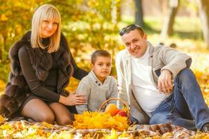 Family playing in autumn park having fun photo