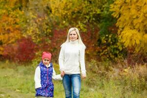 family, childhood, season and people concept - happy family in autumn park photo