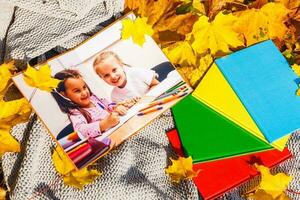 baby photos lie in autumn leaves