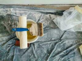 Top view of construction worker desk with things for house renovation. Paintbrush photo