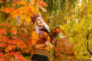 retrato de alegre joven mujer con otoño hojas en frente de follaje haciendo selfie foto