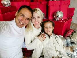 family, christmas, x-mas, winter, happiness and people concept - smiling family with many gift boxes photo