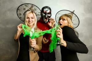 two young beautiful girls wearing witch black dress making party photo