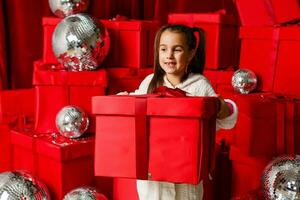 Happy little girl with Christmas gifts photo