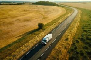 grande azul camión conducción rápido con un blanco remolque con blanco espacio para texto en un campo la carretera con otro carros en contra un azul cielo con un puesta de sol generativo ai foto