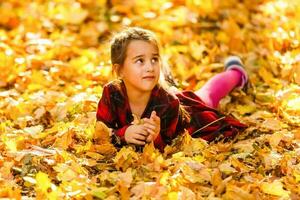 Cute baby girl in the autumn forest photo