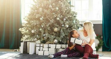 holidays, presents, christmas, x-mas, birthday concept - happy mother and child girl with gift box photo