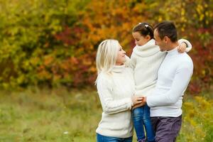 family, childhood, season and people concept - happy family in autumn park photo