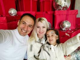 family, christmas, x-mas, winter, happiness and people concept - smiling family with many gift boxes photo