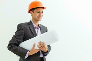 Building worker and architect discussing build drawing on construction site. industrial engineer wearing safety hard hat have meeting commercial building structure photo