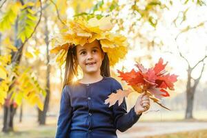 Autumn season leisure. Atmosphere of autumn. Adorable smiling schoolgirl autumn foliage background. Good mood. Happy child. Welcome october. United with nature. Little child walk in autumn park. photo