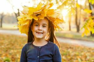 Autumn season leisure. Atmosphere of autumn. Adorable smiling schoolgirl autumn foliage background. Good mood. Happy child. Welcome october. United with nature. Little child walk in autumn park. photo