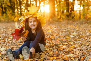 happy little child, girl laughing and playing in the autumn on the nature walk outdoors photo