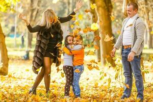 Happy family mother father and baby on autumn walk in the park photo