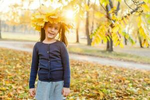 Autumn season leisure. Atmosphere of autumn. Adorable smiling schoolgirl autumn foliage background. Good mood. Happy child. Welcome october. United with nature. Little child walk in autumn park. photo