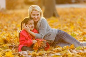 happy family mother and child daughter playing and laughing on autumn walk. photo