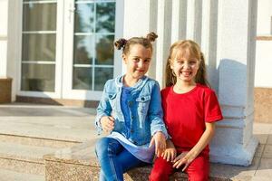 Portrait of happy fashion little girls having fun in the city photo