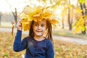 Autumn season leisure. Atmosphere of autumn. Adorable smiling schoolgirl autumn foliage background. Good mood. Happy child. Welcome october. United with nature. Little child walk in autumn park. photo