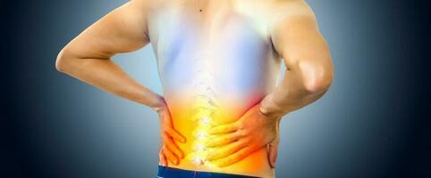 Lower back pain. Man holding his back in pain. Medical concept. photo