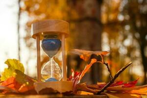 Clock, Hourglasses and Autumn Leaves photo