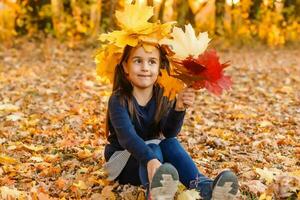 happy little child, girl laughing and playing in the autumn on the nature walk outdoors photo