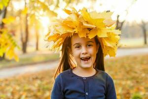 happy little child, girl laughing and playing in the autumn on the nature walk outdoors photo