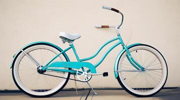 A beach cruiser bike leaning against a wall. photo