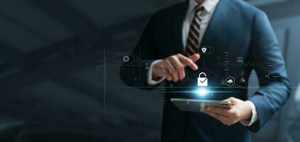 Cyber security and data protection, businessman use secure tablet encryption technology, protect business and financial transaction data from cyber attacks, intelligent protection digital attacks. photo