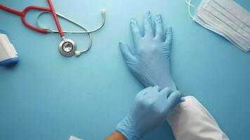 a doctor's hands are wearing gloves and a stethoscope video