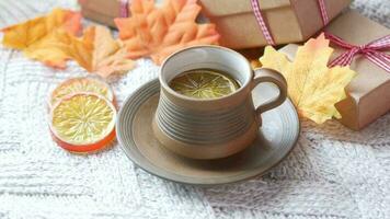 a cup of tea with orange slices and a gift box video