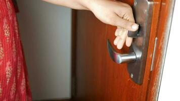 a person opening a door with a metal handle video