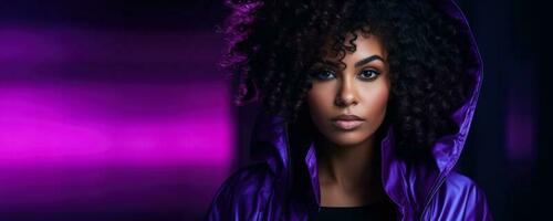 Portrait of a young african american woman in neon on a dark studio background black friday concept purple background with empty space for text photo
