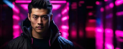 Portrait of a young asian male in neon on a dark studio background cyber monday concept background with empty space for text photo