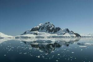 Lemaire strait coast, mountains and icebergs, Antartica photo