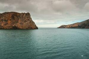 Rugged seascape, Deception Island, Antarctica photo