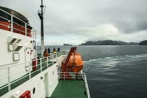 Ship in Deception Island landscape, Antarctica photo