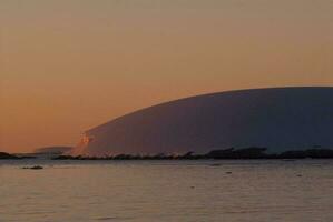 Lemaire strait coastal landscape, mountains and icebergs, Antarctic Peninsula, Antartica. photo