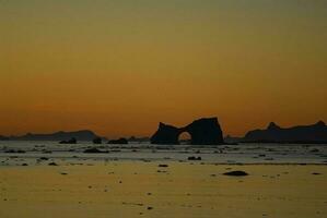 Lemaire strait coastal landscape, mountains and icebergs, Antarctic Peninsula, Antartica. photo