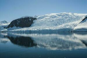 Glacier in Antarctic mountainous landscape, Antartic Peninsula photo
