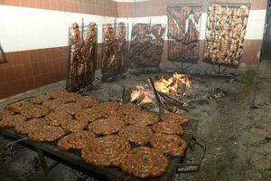 Gaucho roast barbecue, sausage and cow ribs, traditional argentine cuisine, Patagonia, Argentina. photo