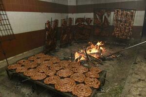 Barbecue, sausage and cow ribs, traditional argentine cuisine, Patagonia, Argentina. photo