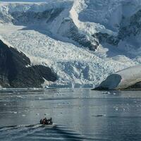 Tourists watching a glacier in Antarctica, near the Antarctic Peninsula. photo