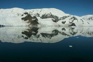 Lemaire strait coast, mountains and icebergs, Antartica photo