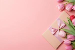 Top view of gift boxes with bows bouquets of tulips envelope with postcard and sprinkles on isolated pastel pink background with copy space, photo