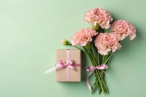 Top view of pink present boxes with ribbon, carnation flowers on a soft pastel green background with copy space, Generative AI photo