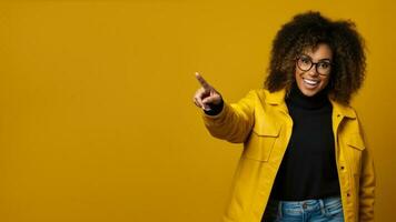 Closeup photo of cool african american woman pointing to empty space for black friday prices on a yellow background