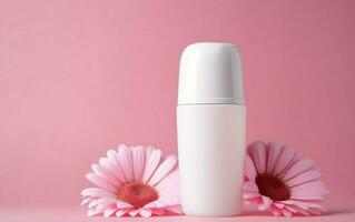 White cosmetic bottle with flower on pink background photo