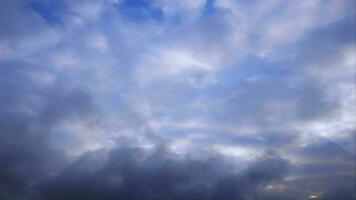 White clouds roil across a blue sky - Loop video