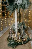 A candle in a candlestick decorated in a Christmas theme. A decor concept for home decoration for the New Year holidays, table decoration for Christmas. photo